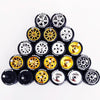 A collection of ten pairs of 1:64 scale alloy car wheels and tires arranged in a pyramid formation.