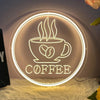 A glowing neon sign depicting a steaming cup of coffee with the word COFFEE on it, displayed against a dark wall.