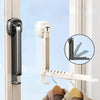 A wall-mounted clothes drying rack with an adhesive mount is shown installed on a window frame.