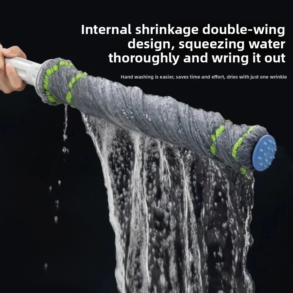 A hand is squeezing a grey double-wing internal shrinkage mop thoroughly and wringing it out.