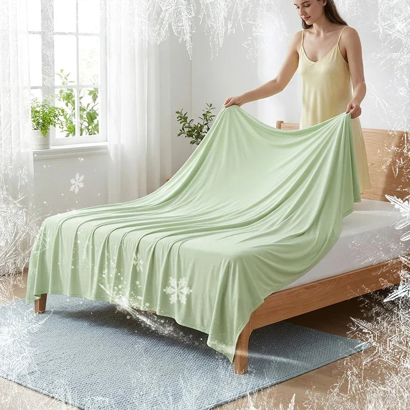 A light green ice silk blanket is draped over a wooden bed, with frost effects visible on the fabric and surrounding area.