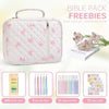 A pink floral quilted Bible cover with a zipper pocket and carry handle, shown next to various stationery items.