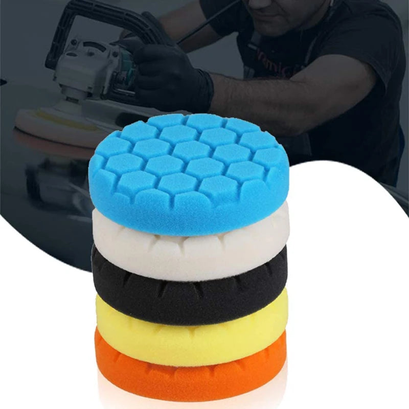 A stack of five colored polishing sponge pads, including blue, white, black, yellow, and orange.