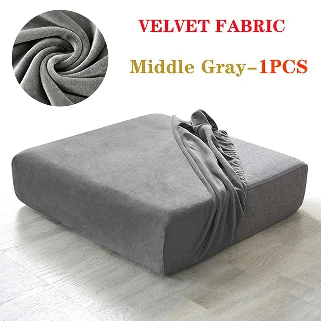 A gray velvet fabric sofa cover displayed on a floor, showing the texture and drape of the material.