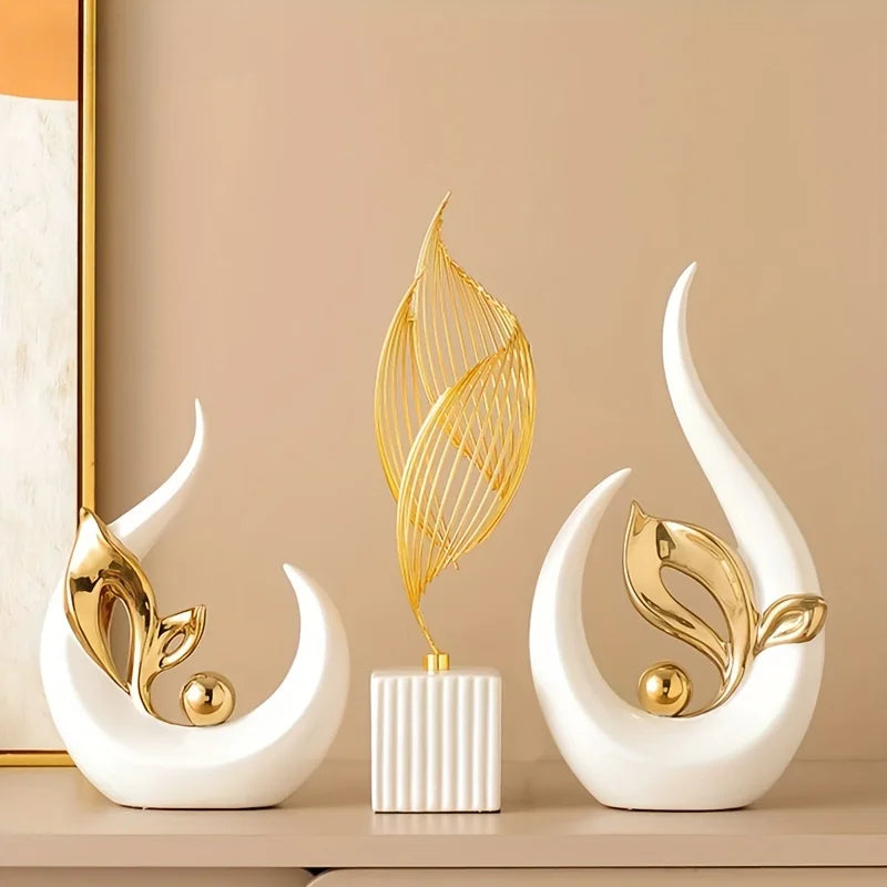 A set of white ceramic sculptures featuring gold leaf designs for modern home and office decor.