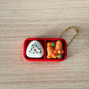 A red box contains a white cake-shaped fidget item and two orange cartoon figures.