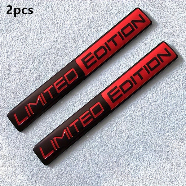 Two black metal racing emblem decals with red lettering on a light blue textured background.