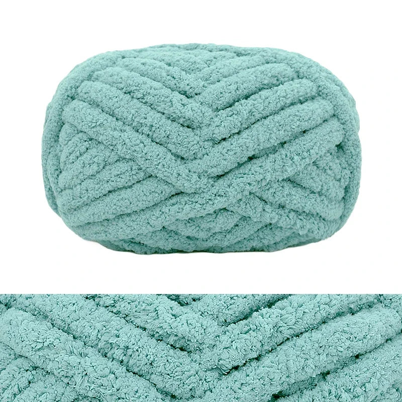 A ball of light blue chunky chenille yarn with a textured, braided pattern.