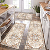 A long, rectangular beige and brown patterned kitchen rug laid on a dark wood floor.
