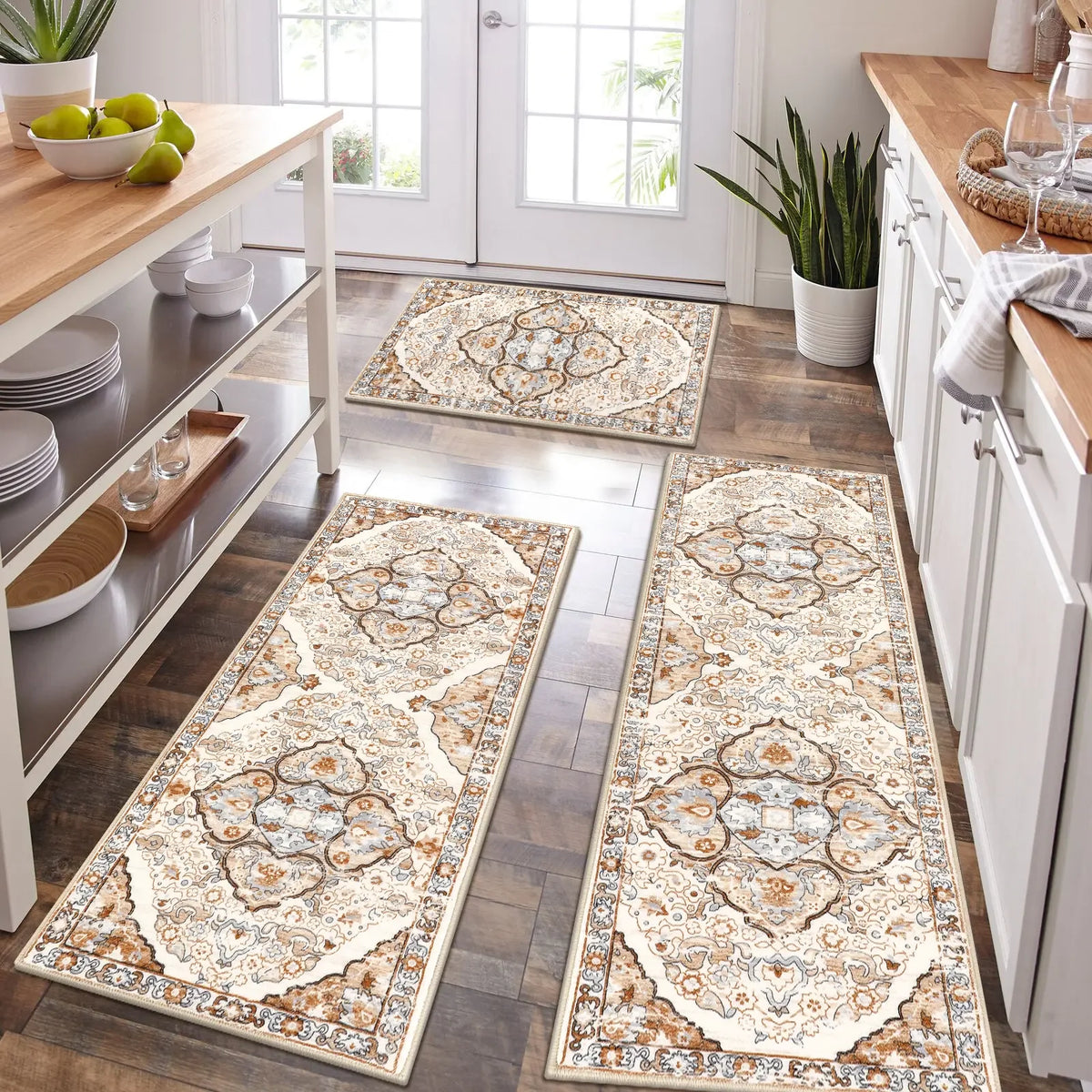 A long, rectangular beige and brown patterned kitchen rug laid on a dark wood floor.