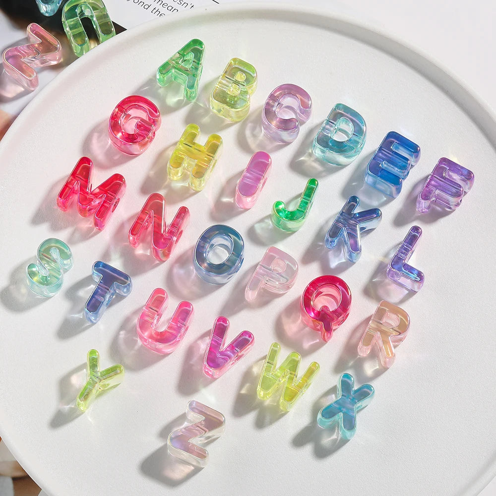 A collection of colorful acrylic alphabet beads in various shapes and colors arranged on a white plate.