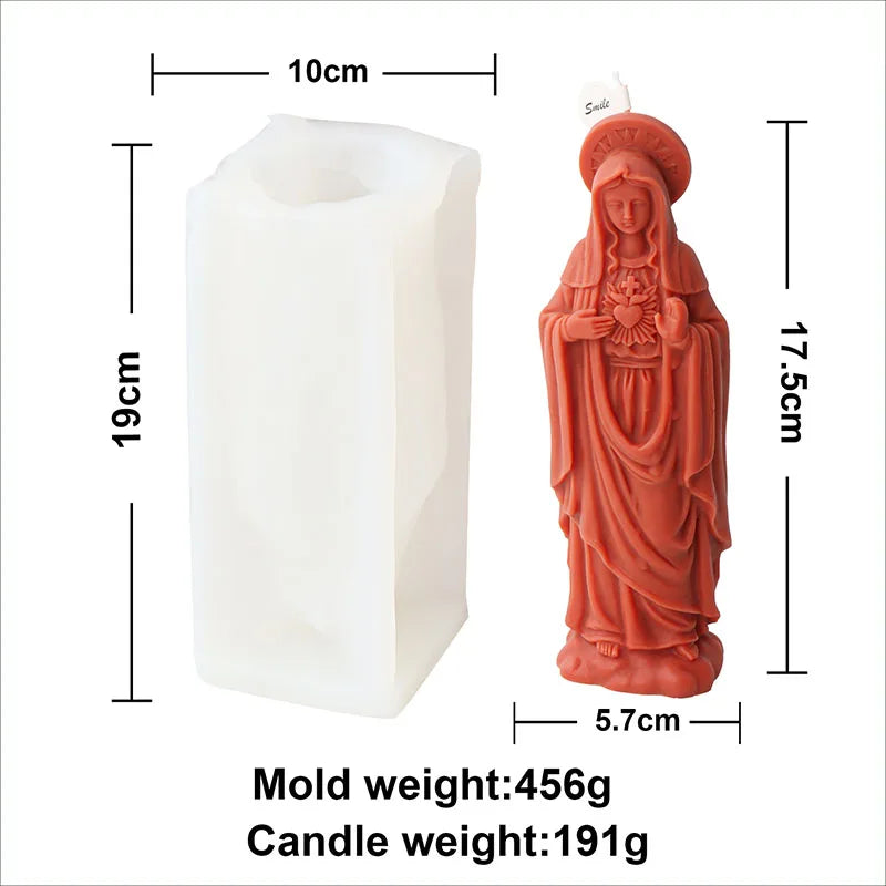 A tall white silicone mold for a religious candle, next to the finished orange-colored candle.