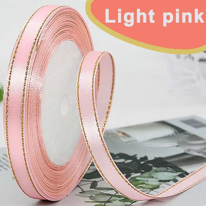 Roll of light pink gold-edge satin ribbon for crafts and gift wrapping
