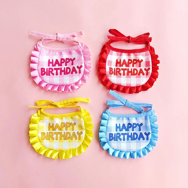 A set of four fabric birthday hats and bibs for pets in pink, red, yellow, and blue plaid patterns.