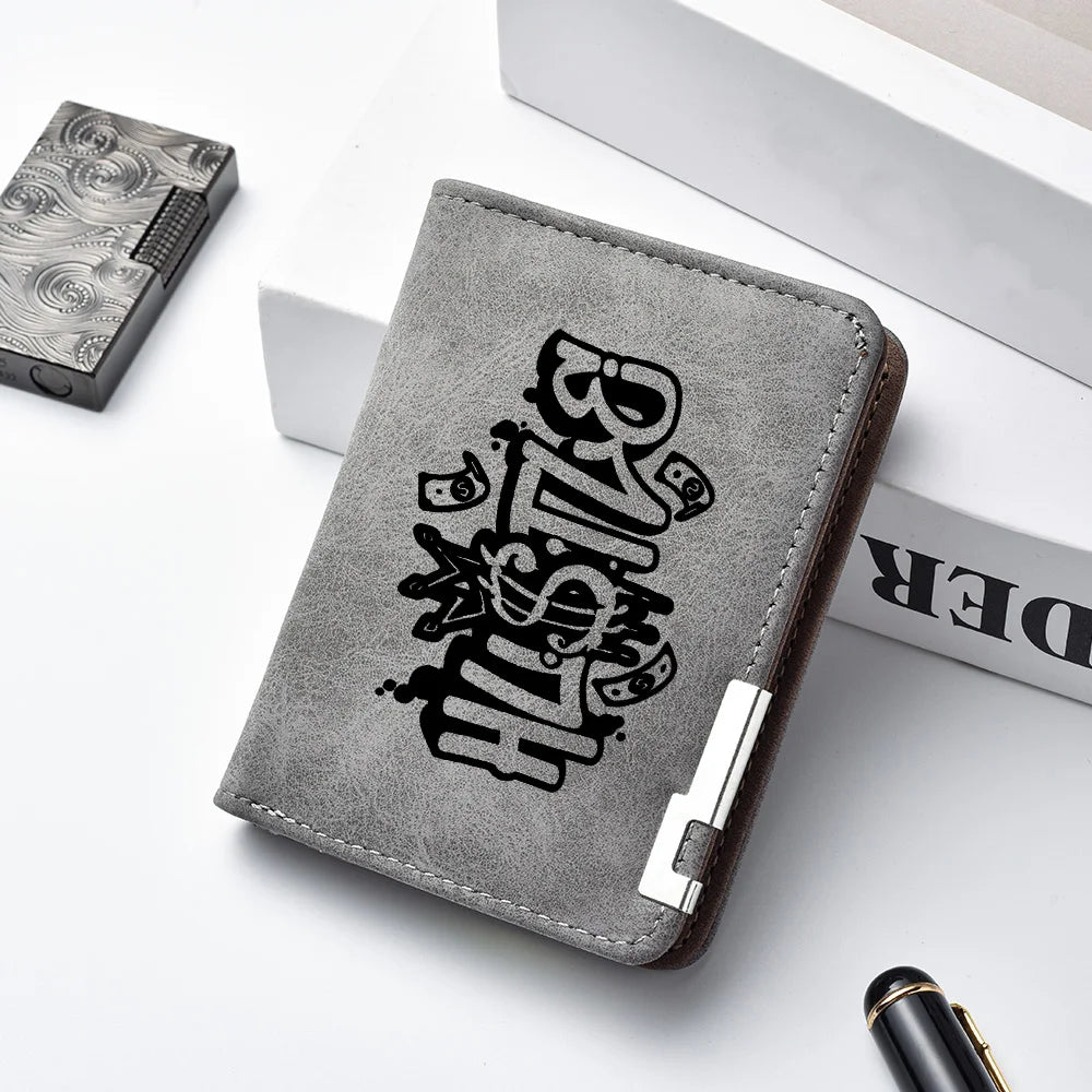 A dark gray men's compact double-fold wallet with embossed lettering is shown on a white surface.