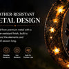 A metal design featuring a black cat and pumpkin carved into a crescent moon shape, illuminated by warm lights.