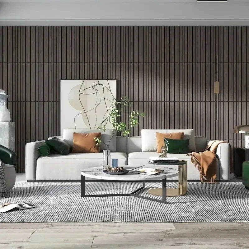 A modern living room featuring a light sofa, decorative pillows, and a dark wood-paneled accent wall.