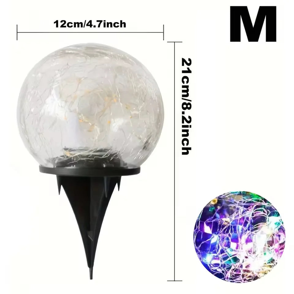 Lumière en verre craquelé avec une base noire et un insert de fibres lumineuses colorées.