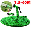 Green expandable magic hose with 7 spray patterns and a green nozzle spraying water onto a green mat.