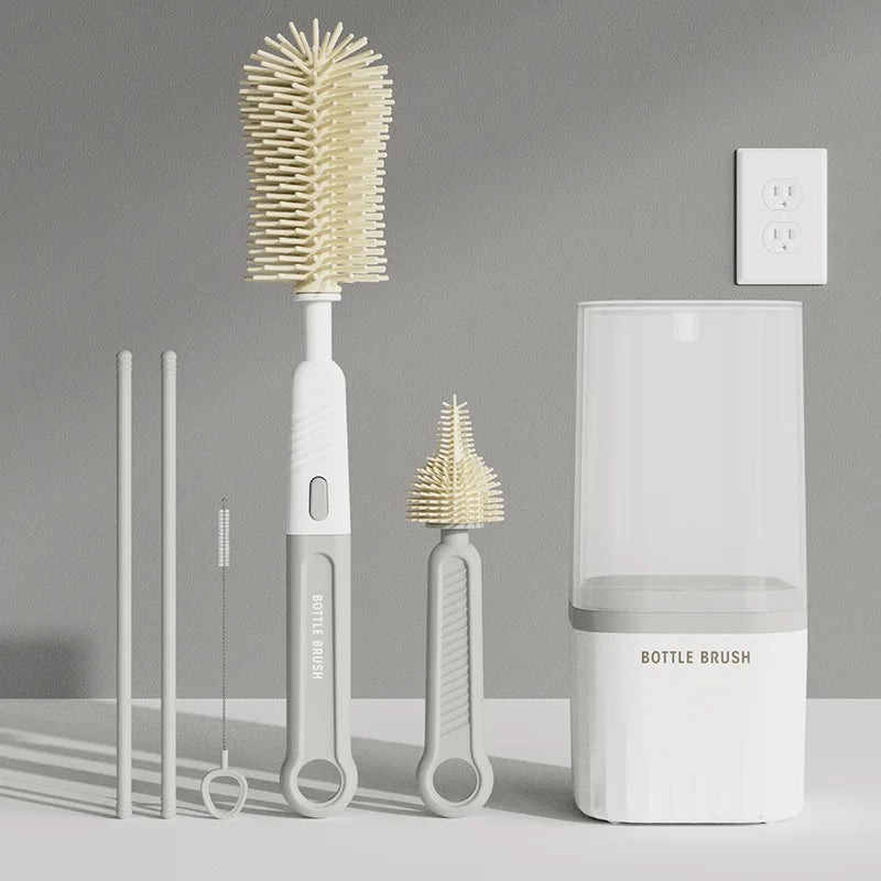 A set of silicone baby bottle brushes, including a main brush and two smaller brushes, displayed on a light gray surface.