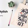 A beige canvas tote bag featuring a graphic design with text and illustrations, set against a white background.