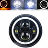A close-up view of a round motorcycle LED headlight with angel eyes and daytime running lights.