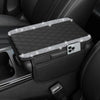 A black diamond quilted car armrest cover with a storage compartment and a phone holder.