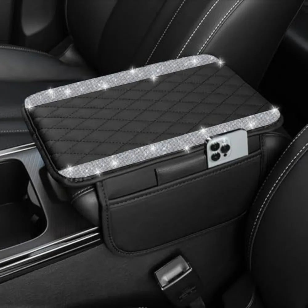 A black diamond quilted car armrest cover with a storage compartment and a phone holder.
