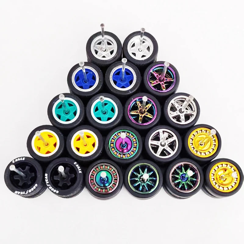 A collection of ten 1:64 scale alloy car wheels and tires arranged in a pyramid formation.