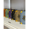 A collection of six fantasy theme model book building blocks in various colors and designs displayed on a white surface.
