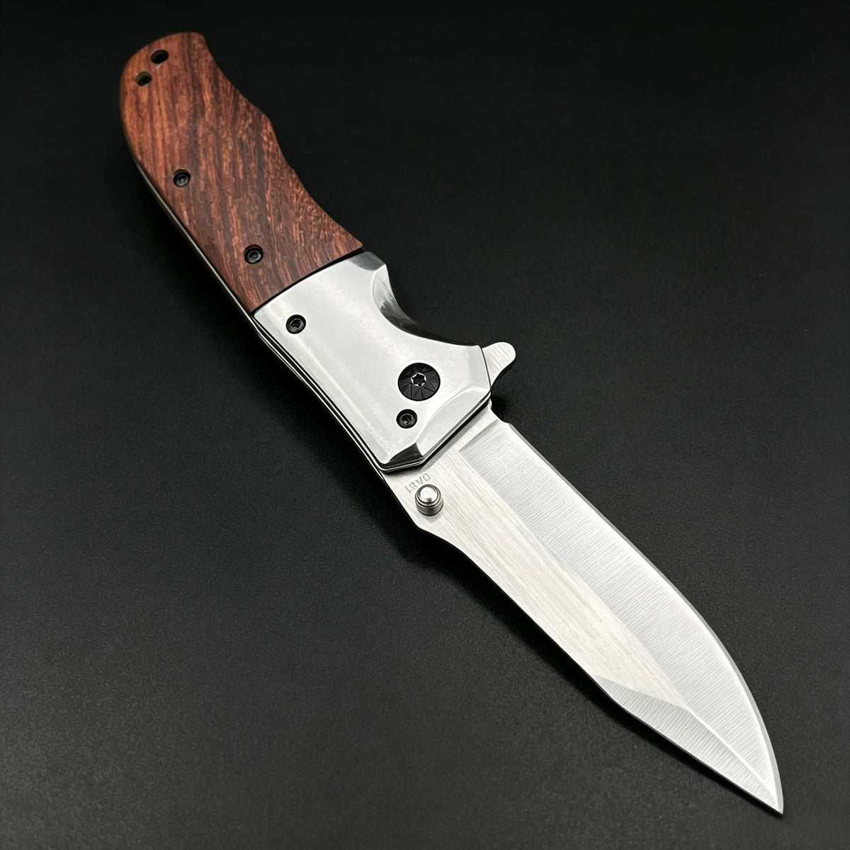 A folding pocket knife featuring a walnut wood handle and a stainless steel blade, shown in profile.