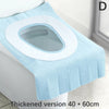 A light blue disposable toilet seat cover with a white rim is shown on a toilet.