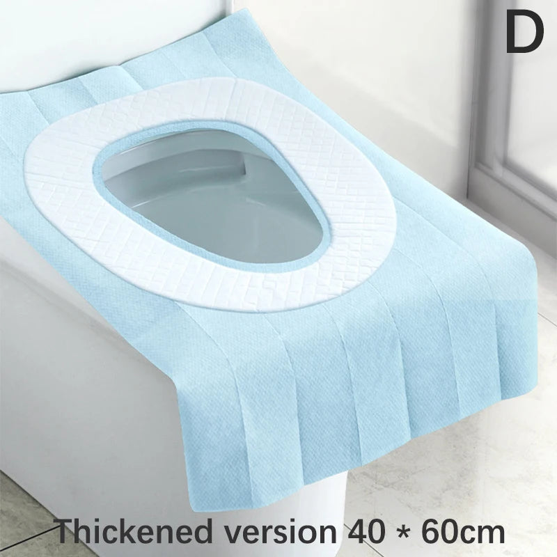A light blue disposable toilet seat cover with a white rim is shown on a toilet.