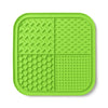 A bright lime green silicone lick mat for pets with a grid pattern and suction cups.