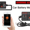 A car battery monitor device and cables are shown next to a hand holding a smartphone.