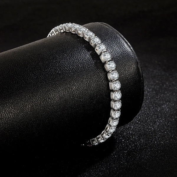Rapproché d'un bracelet de tennis en argent sterling orné de zircons clairs, présenté sur une surface noire.