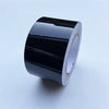A roll of glossy black vinyl wrap strip for car trim and protection.