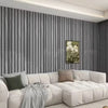 A modern living room wall decorated with vertical gray wood grain wallpaper and a white sofa.