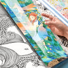 A hand is holding an open diamond painting storage book showing colorful artwork and a black line drawing.