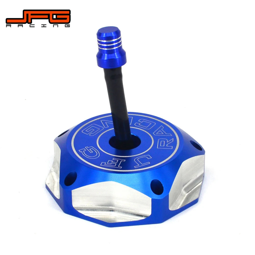 A blue and silver CNC aluminum motorcycle fuel tank cap with a black threaded stem.