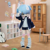 A light blue articulated ball-jointed doll figurine with pink accents and a dark blue jacket standing on a wooden floor.
