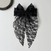 Black lace bow hair clip for women with a sheer fabric detail