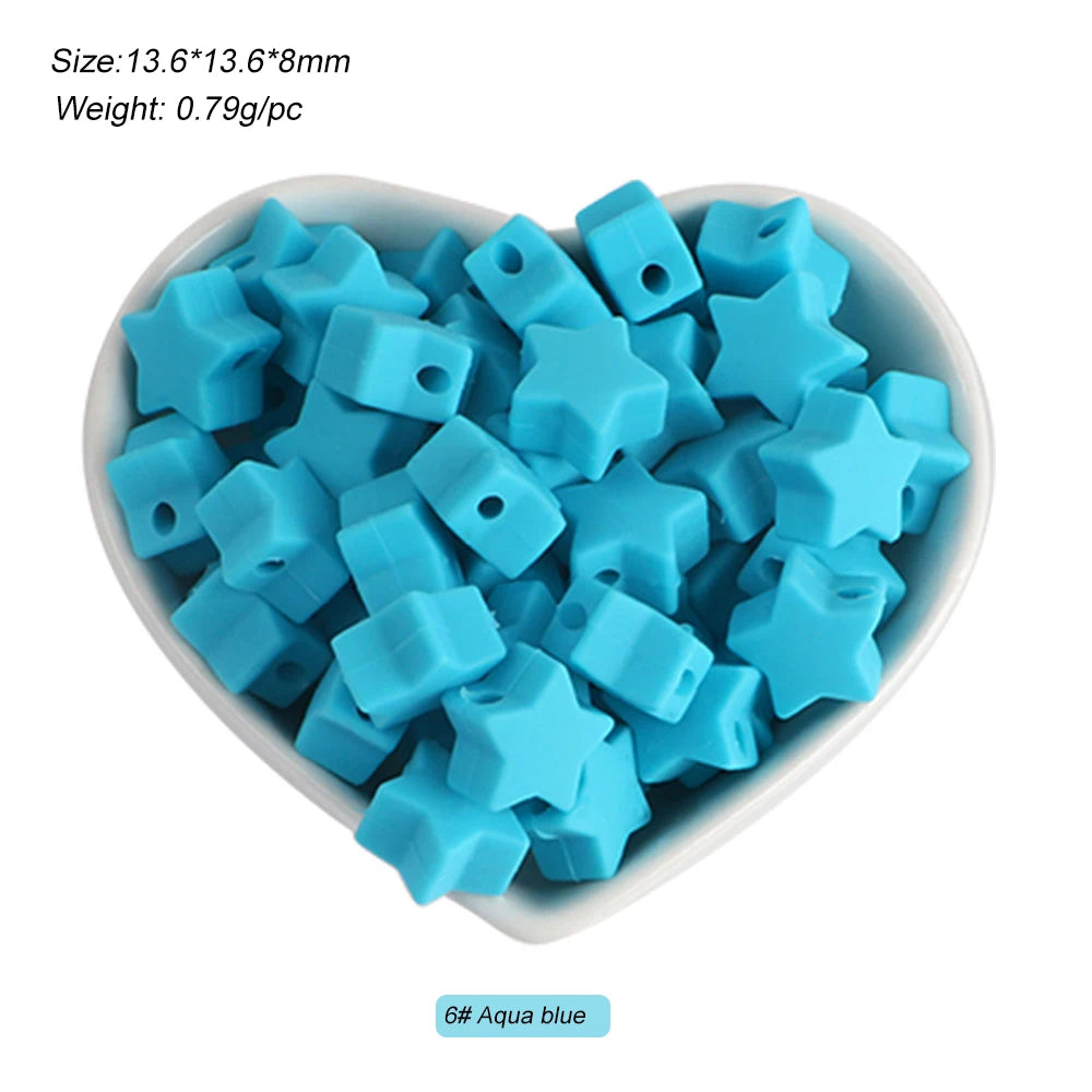 A pile of light blue silicone crown star heart beads for DIY jewelry making