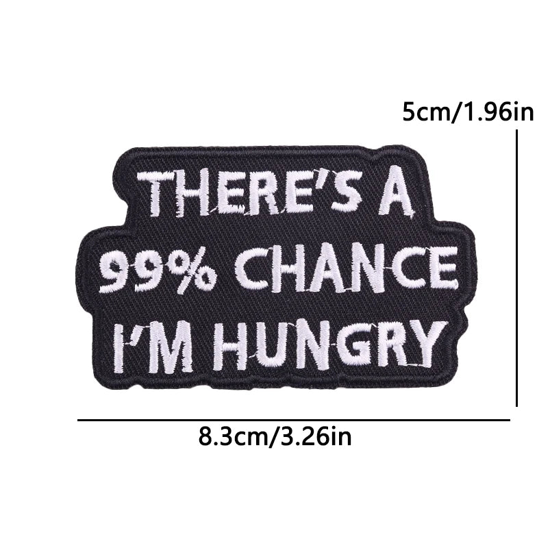 Black embroidered iron-on patch with white text that reads There's a 99% chance I'm hungry