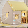 A beige play tent shaped like a house with a yellow checkered roof and decorative elements for children.
