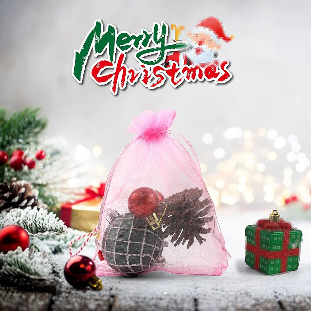 Pink organza drawstring bags filled with festive decorations and gifts for Christmas