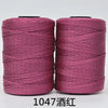 Spool of pink 3-ply polyester knitting yarn for crochet and hand crafts