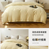 A light beige washed cotton brushed duvet cover displayed on a bed with white pillows and wooden flooring.
