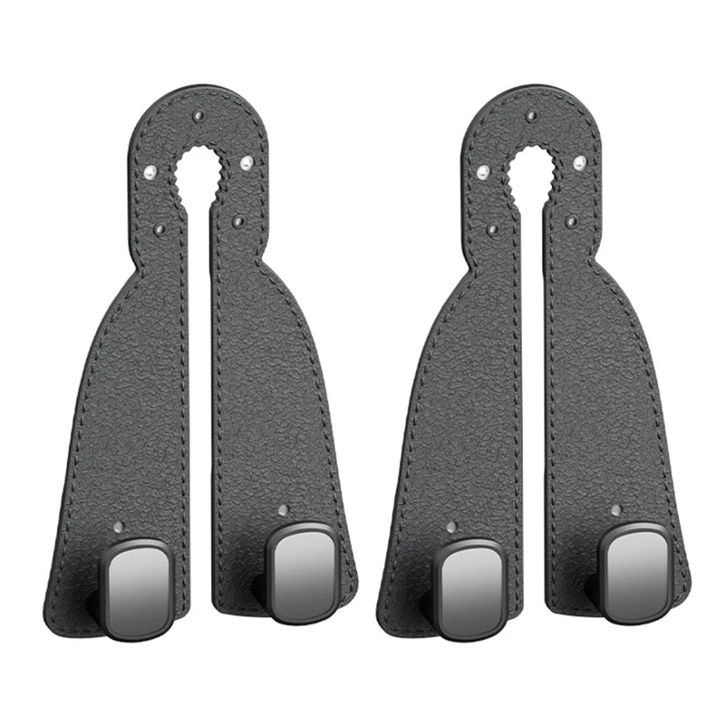 A pair of black leather headrest hooks designed as a tidy organizer for bags, groceries, and coats.