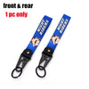 A blue lanyard with white text Night Riders and a black clasp keychain.
